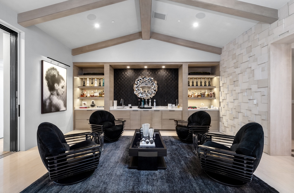 This black and white living room has a fantastic overall appearance. The wooden beams divide the roof into two symmetrical sides. At the same time, the decoration is balanced and appealing in depth, from the layout of the display cabinets to the position of the sofa set. Despite its simplicity, the entire room is upgraded and becomes luxurious, thanks to the most important interior of the living room, a modern black sofa set.