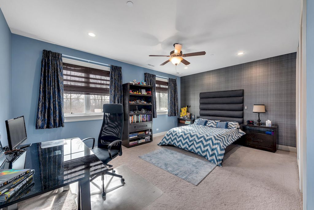 Blue and gray are two luxurious paint colors to use in your bedroom. The highlights of this room are expensive silk curtains and a modern working table.