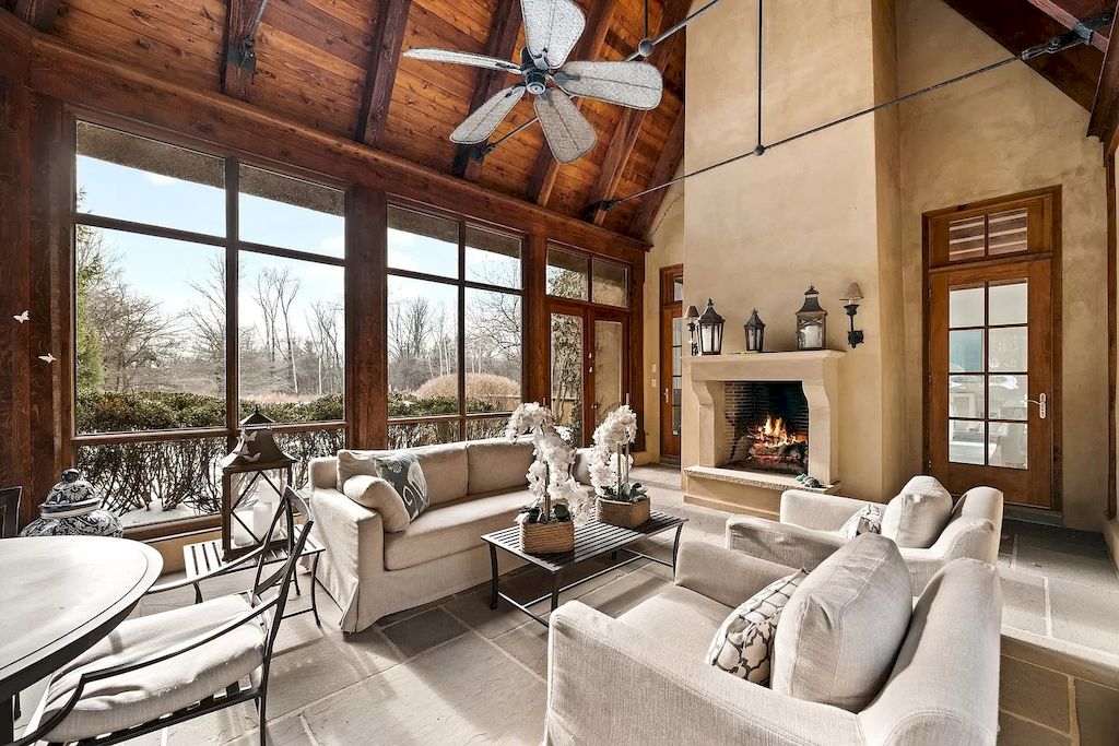 With a stone fireplace surrounding, a living room might have a little bit of a farmhouse feel. You don't have to go all out with a huge stone fireplace and hearth to achieve the whole effect, as this room, courtesy, shows. Stone is used in this fireplace's design to give it a cozy and welcoming farmhouse feel.