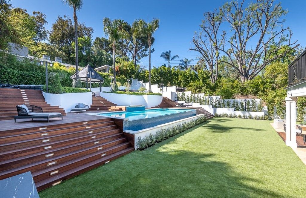 The Farmhouse in Encino is a unparalleled luxury and exquisite design with resort-styled rear oasis features a heated pavilion, perfect for outdoor dining now available for sale. This home located at 4651 Louise Ave, Encino, California
