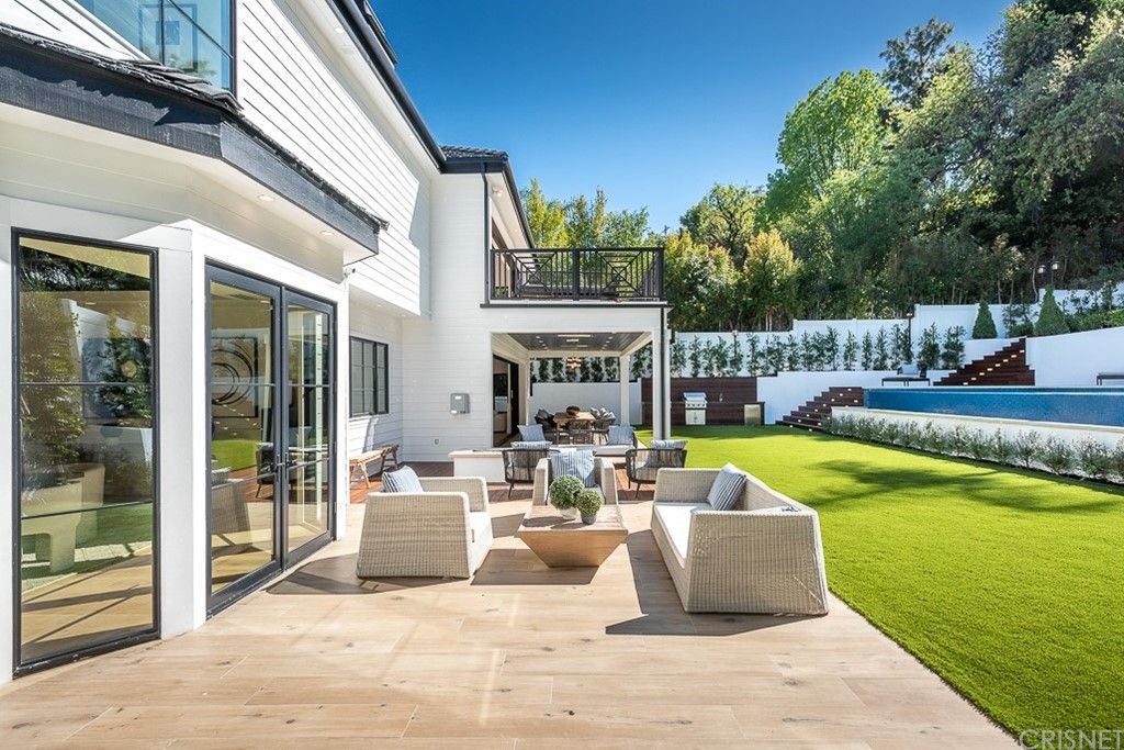 The Farmhouse in Encino is a unparalleled luxury and exquisite design with resort-styled rear oasis features a heated pavilion, perfect for outdoor dining now available for sale. This home located at 4651 Louise Ave, Encino, California