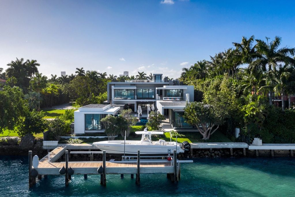 The Mansion in Miami Beach is a modern masterpiece with 100 ft of waterfront facing east with ocean breeze and sunrises now available for sale. This home located at 27 Star Island Dr, Miami Beach, Florida