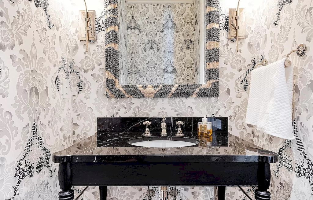 For a bold bathroom backsplash, go with a graphic pattern. Patterned black-and-white tiles extend to the ceiling here, providing a striking focal point along the vanity wall. The ornamental tile designs that may be mixed and matched provide texture and complexity to the bathroom backsplash.