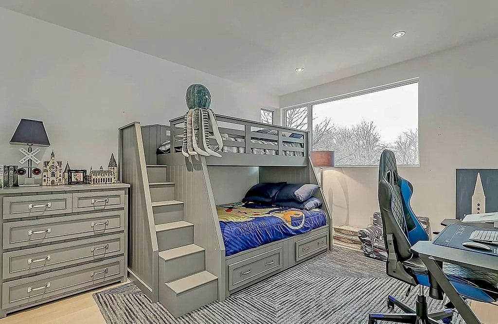 A loft bed with a coastal theme and a light feel is the next best thing to a beach house. This bedroom is transformed into a seaside retreat by the neutral backdrop with light blue accents scattered throughout and the marine-tone blanket. 