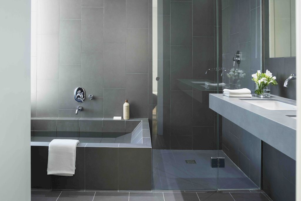 Because of their variety of patterns and ability to protect walls from excessive moisture, ceramic tiles are always a top choice in bathrooms. However, not many designs, such as this luxury ideas design, will use ceramic tiles throughout the bath. Despite the fact that only gray is used throughout and covers the entire space, this room is always unique and appealing.