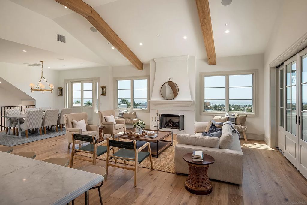 impact of minimalist interiors. The handcrafted neutral sofa set with black chairs is installed to showcase a mix of mid-century modern and vintage touches. The vaulted ceiling and wooden floor make the furniture stand out more than ever.