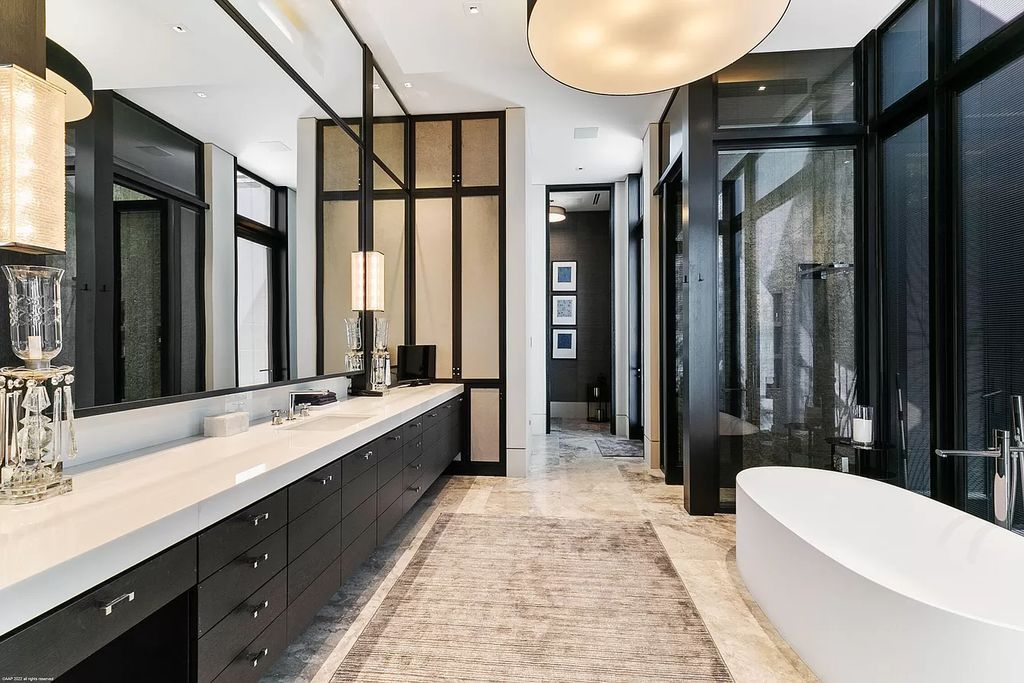 The white and black combo in the design of any space is considered the standard of timeless beauty and harmony. You will never have to worry about going out of style or having to change the interior to match the trend. As in the above Luxury Bathroom Ideas, white is used for the wall paint, the sink and the delicate round-shaped bathtub are contrasted with the black color of the door frame and storage shelves, making the whole bathroom space stylish.