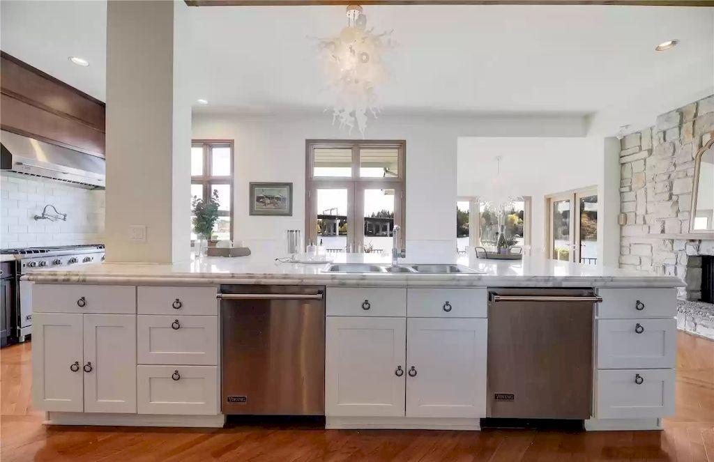 The Estate in Washington is a luxurious home featuring incredible chef kitchen of 6 burner Viking range with double oven, oversize Sub Zero refrigerator, 2 dishwashers, abundant storage, and an immense marble island now available for sale. 