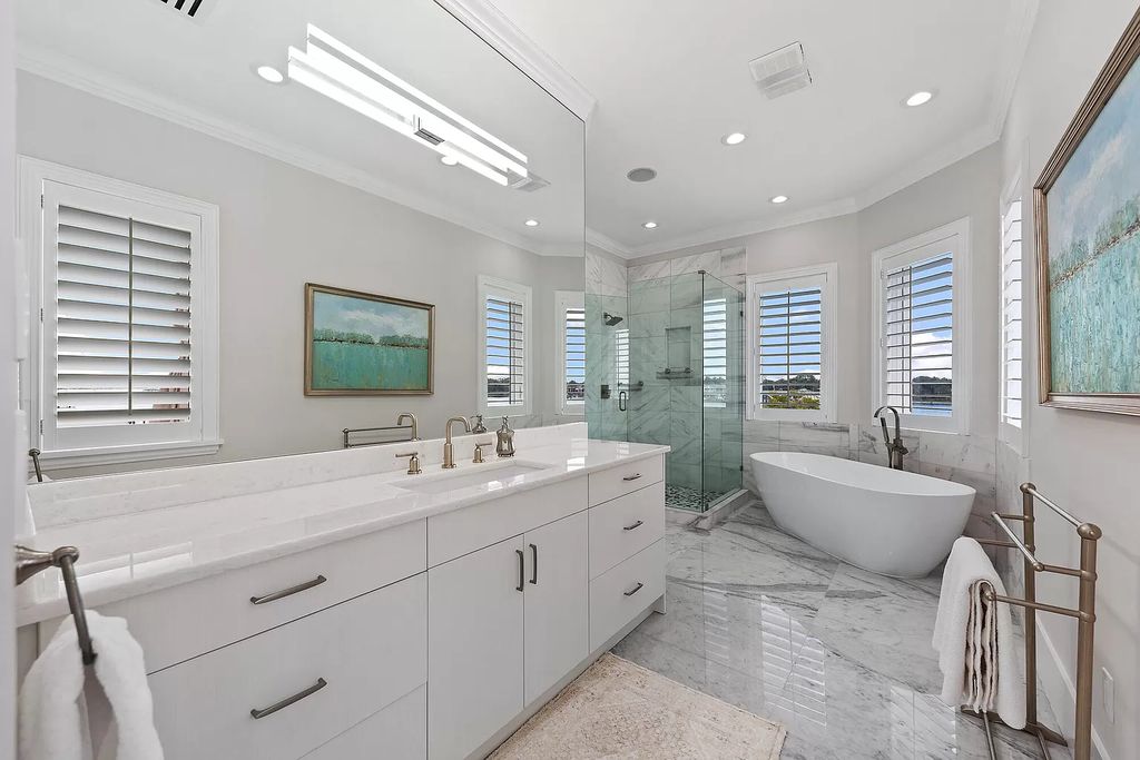 The Home in Jupiter is a newly renovated transitional custom estate with detached guest house, private tennis court and 2 gated entries for complete privacy now available for sale. This home located at 19000 Point Dr, Jupiter, Florida