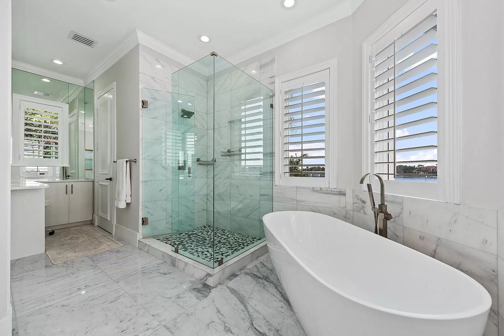 The Home in Jupiter is a newly renovated transitional custom estate with detached guest house, private tennis court and 2 gated entries for complete privacy now available for sale. This home located at 19000 Point Dr, Jupiter, Florida