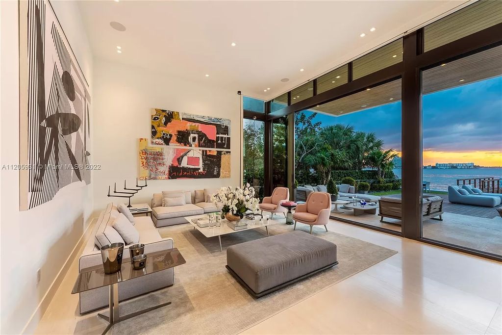 The Home in Miami Beach is a modern waterfront with a western exposure capturing unobstructed water views and dramatic sunsets over Biscayne Bay now available for sale. This home located at 2608 Biarritz Dr, Miami Beach, Florida