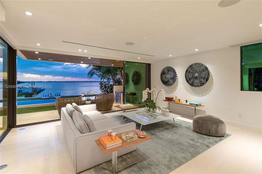 The Home in Miami Beach is a modern waterfront with a western exposure capturing unobstructed water views and dramatic sunsets over Biscayne Bay now available for sale. This home located at 2608 Biarritz Dr, Miami Beach, Florida