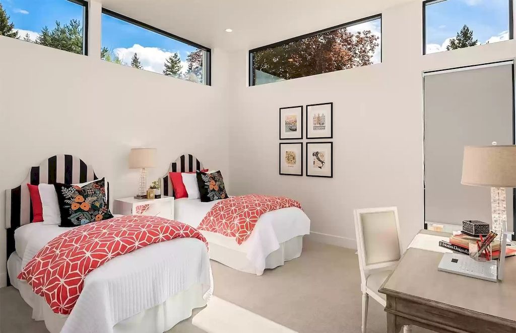 This is a black and white bedroom design, but it is anything but boring. Natural light enters the room through the glass windows. Decorative motifs add visual interest.
