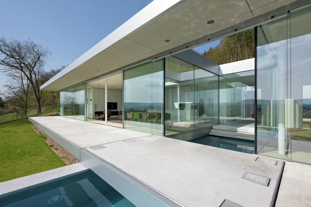 Villa K lies long and low on a German hillside by Paul de Ruiter Architects