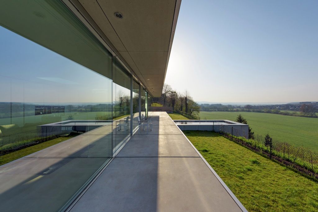 Villa K lies long and low on a German hillside by Paul de Ruiter Architects