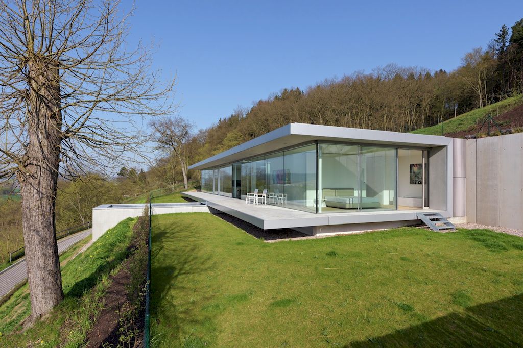 Villa K lies long and low on a German hillside by Paul de Ruiter Architects