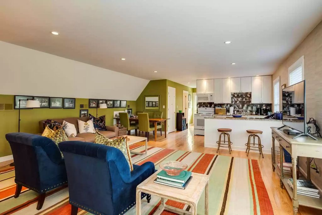 There isn't enough area for a separate breakfast nook, living room, or dining room. Take this as an example. The green wall serves as a terrific showcase area in addition to connecting the different areas. The no-door architectural design method can make the open floor plan layout look excellent with the right-sized furnishings.