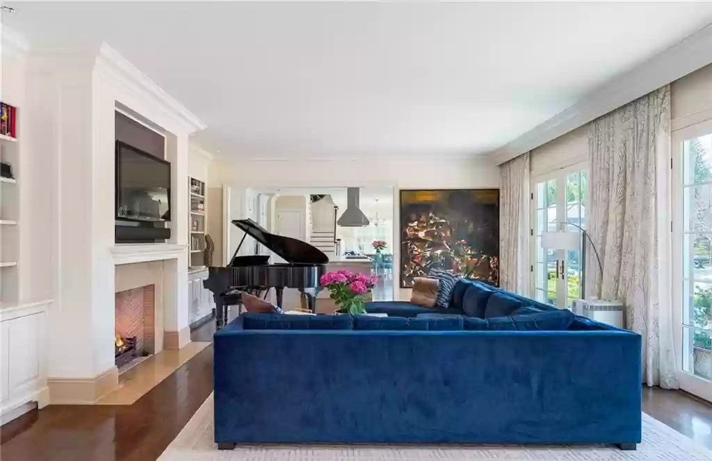 As this striking blue living room demonstrates, elegant living room ideas aren't limited to neutral color schemes. Modern items are paired with traditional Seventies furniture in this area, which has a more whimsical take on elegance. The antiques also hint to the home's history while contributing to the overall opulent atmosphere.