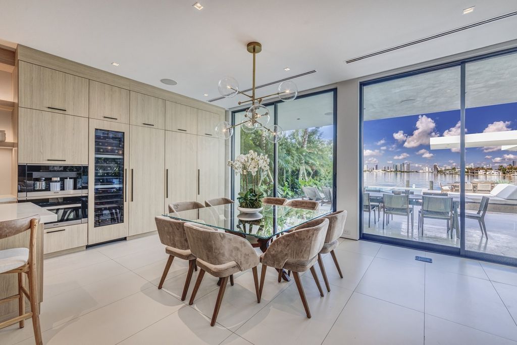 The Home in Miami Beach is a magnificent modern estate fully furnished with only the best  with spectacular, direct, downtown wide-bay views now available for sale. This home located at 100 W San Marino Dr, Miami Beach