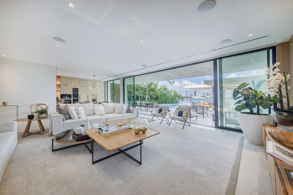 The Home in Miami Beach is a magnificent modern estate fully furnished with only the best  with spectacular, direct, downtown wide-bay views now available for sale. This home located at 100 W San Marino Dr, Miami Beach