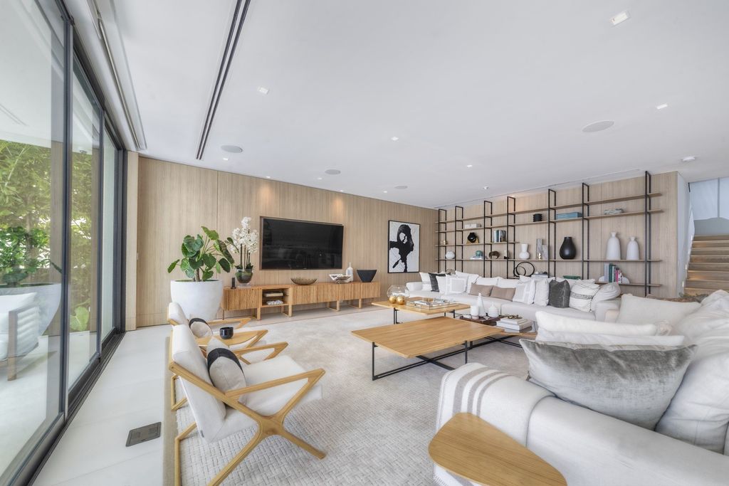 The Home in Miami Beach is a magnificent modern estate fully furnished with only the best  with spectacular, direct, downtown wide-bay views now available for sale. This home located at 100 W San Marino Dr, Miami Beach