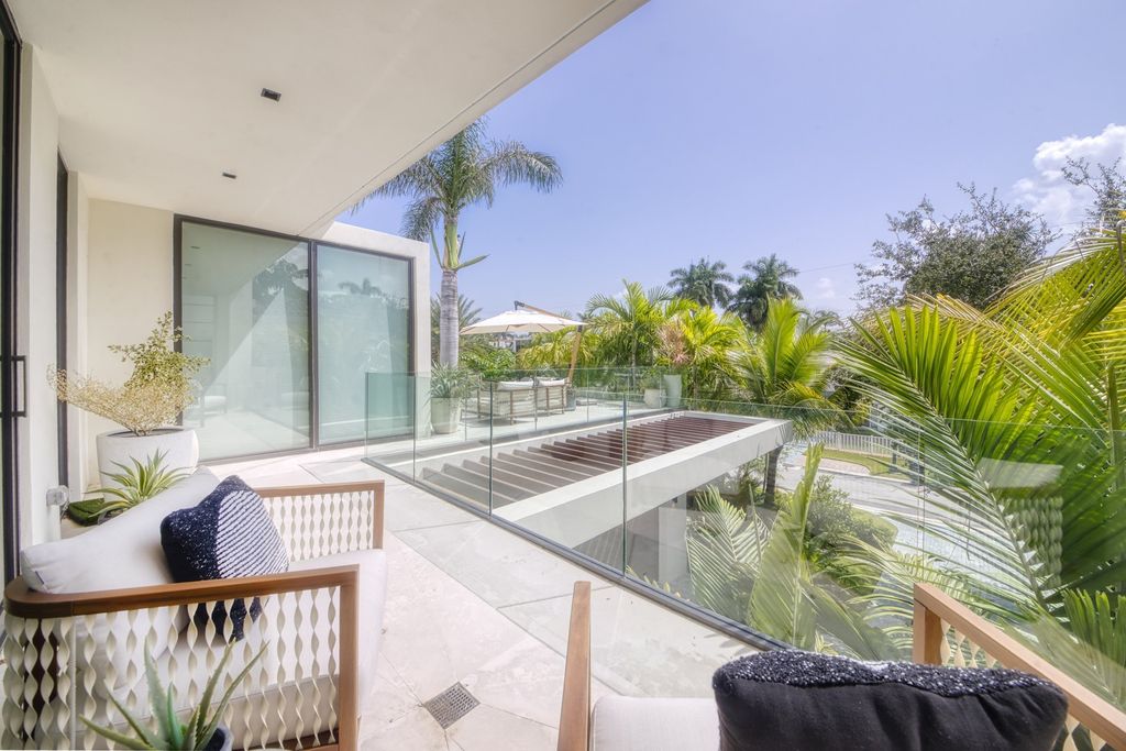 The Home in Miami Beach is a magnificent modern estate fully furnished with only the best  with spectacular, direct, downtown wide-bay views now available for sale. This home located at 100 W San Marino Dr, Miami Beach