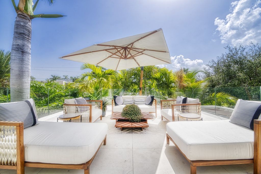 The Home in Miami Beach is a magnificent modern estate fully furnished with only the best  with spectacular, direct, downtown wide-bay views now available for sale. This home located at 100 W San Marino Dr, Miami Beach