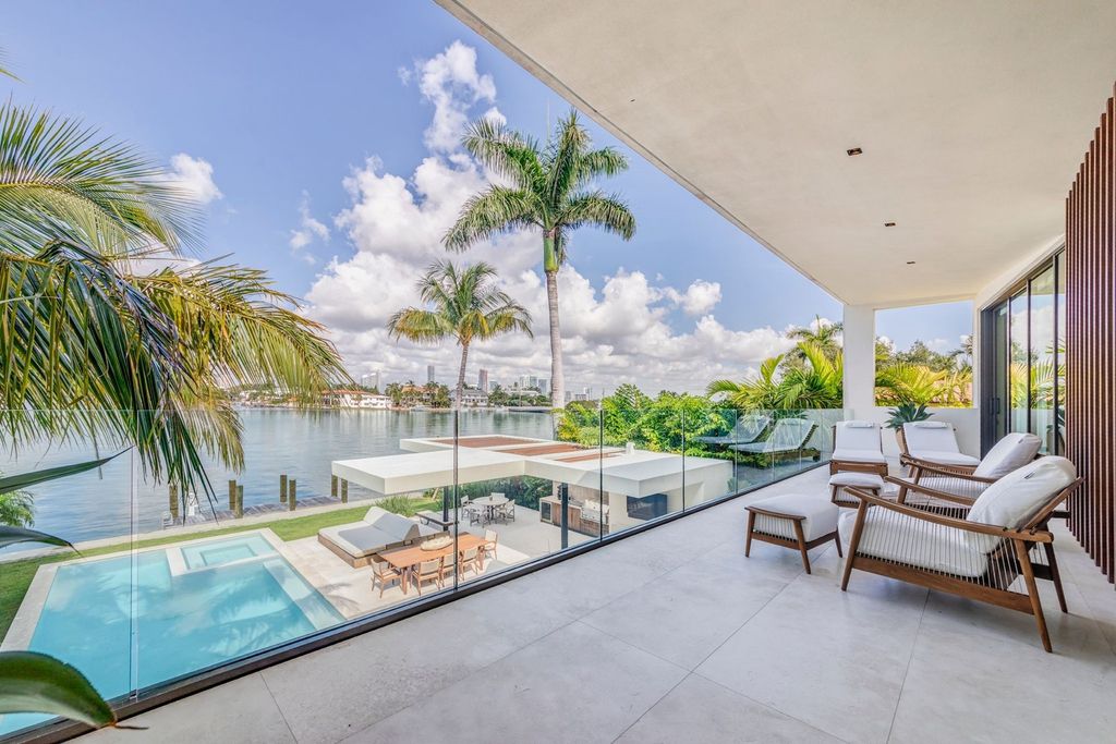The Home in Miami Beach is a magnificent modern estate fully furnished with only the best  with spectacular, direct, downtown wide-bay views now available for sale. This home located at 100 W San Marino Dr, Miami Beach