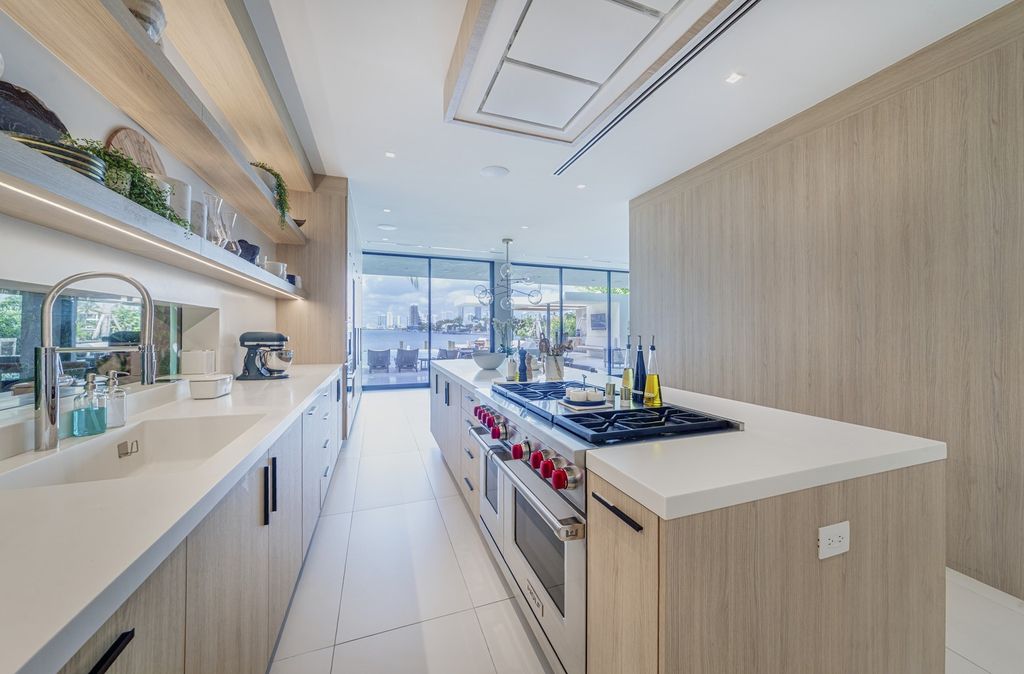 The Home in Miami Beach is a magnificent modern estate fully furnished with only the best  with spectacular, direct, downtown wide-bay views now available for sale. This home located at 100 W San Marino Dr, Miami Beach