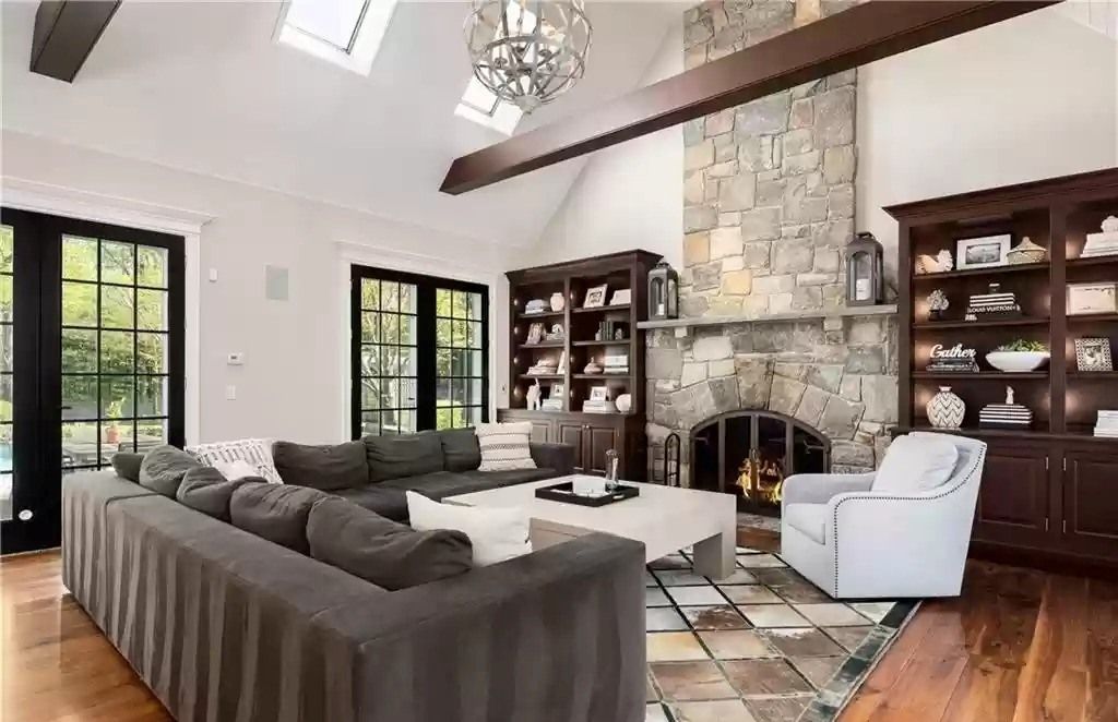The fireplace is the focal point of the living room because it is always located in the center of the room, where people gather. In this design, the homeowner used natural stone to cover the entire exterior of the fireplace. The tone of the natural stones is also very marching with the color of the carpet and the L-shape sofa set in the living room.