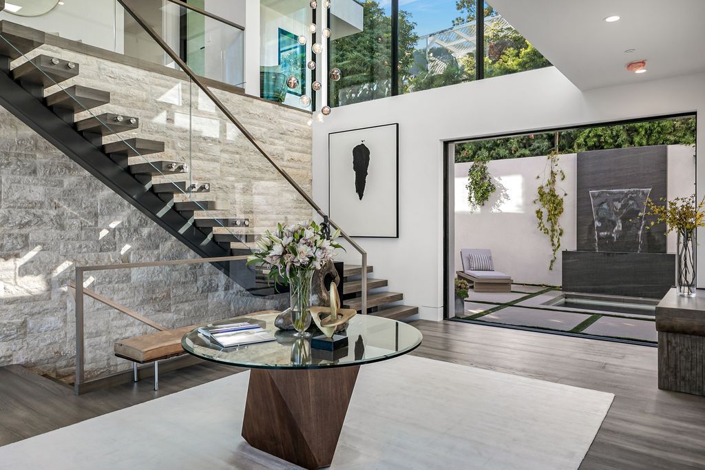 The Home in Pacific Palisades is a new contemporary home personifies abstract reductionist minimalism perched above the trees in the highly coveted Riviera now available for sale. This home located at 1635 Casale Rd, Pacific Palisades, California