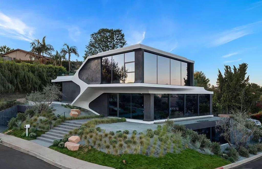 The Home in Bel Air is an unique residence in the highly coveted hills of Bel Air has an automotive inspired intelligible shell and was CNC milled from digital design now available for sale. This home located at 1254 Roberto Ln, Los Angeles, California