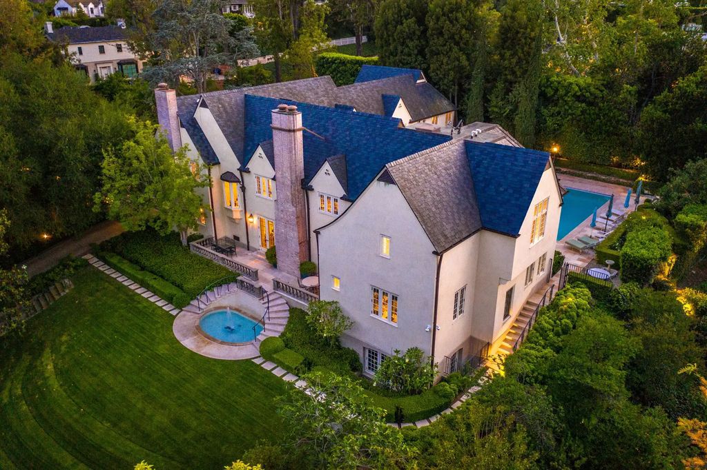 The Home in Los Angeles is a traditional estate in the heart of prime Little Holmby offers an enchanting setting with meticulously manicured grounds, captivating faade, and timeless authenticity now available for sale. This home located at 10301 Strathmore Dr, Los Angeles, California
