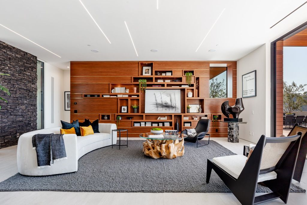 Many people appreciate the design that blends in with nature. Living room with exquisitely sculpted natural wood coffee table. The sophistication of a wooden display cabinet is also a focal point in this room.