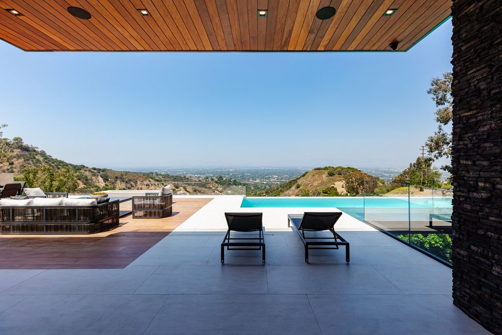 The Home in Beverly Hills is a brand new architectural masterpiece inspired by the surrounding landscape and committed to complete harmony with nature now available for sale. This home located at 12945 Mulholland Dr, Beverly Hills, California