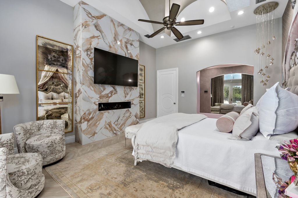 The Home in Bryan, a luxurious custom residence has a open concept great room complete with 20-foot ceilings, a beautifully designed pool and elegant outdoor entertaining area. This home located at 7163 Riverstone Dr, Bryan, Texas.