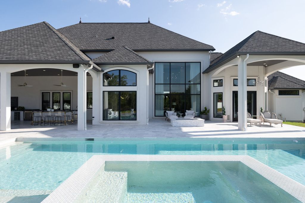 The Home in Bryan, a luxurious custom residence has a open concept great room complete with 20-foot ceilings, a beautifully designed pool and elegant outdoor entertaining area. This home located at 7163 Riverstone Dr, Bryan, Texas.