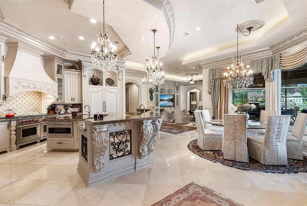 The Home in The Woodlands, a beautiful waterfront property features dramatic high ceilings, elegant lighting and Italian chandeliers, custom millwork, luxury fixtures. This home located at 2 W Isle Pl, The Woodlands, Texas