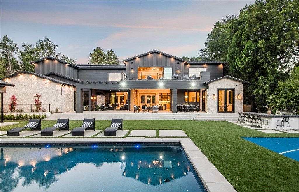 The Farmhouse in Encino, Exquisite new construction gated estate in the coveted enclave of Royal Oaks neighborhood with the sprawling grounds featuring a sparkling pool & spa, sports court, spacious elevated patio, grass area. This home located at 15825 Woodvale Rd, Encino, California
