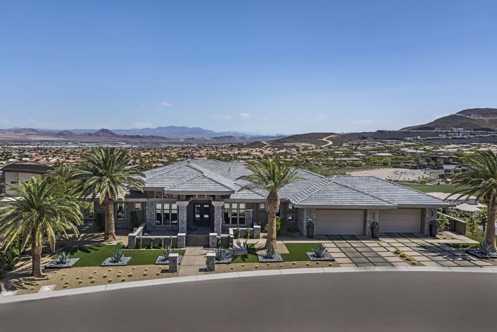 The Estate in Henderson, a custom guard-gated 2-story built on a premium hillside lot with incredible mountain, city, and golf course views is now available for sale. This home located at 1474 Reims Dr, Henderson, Nevada