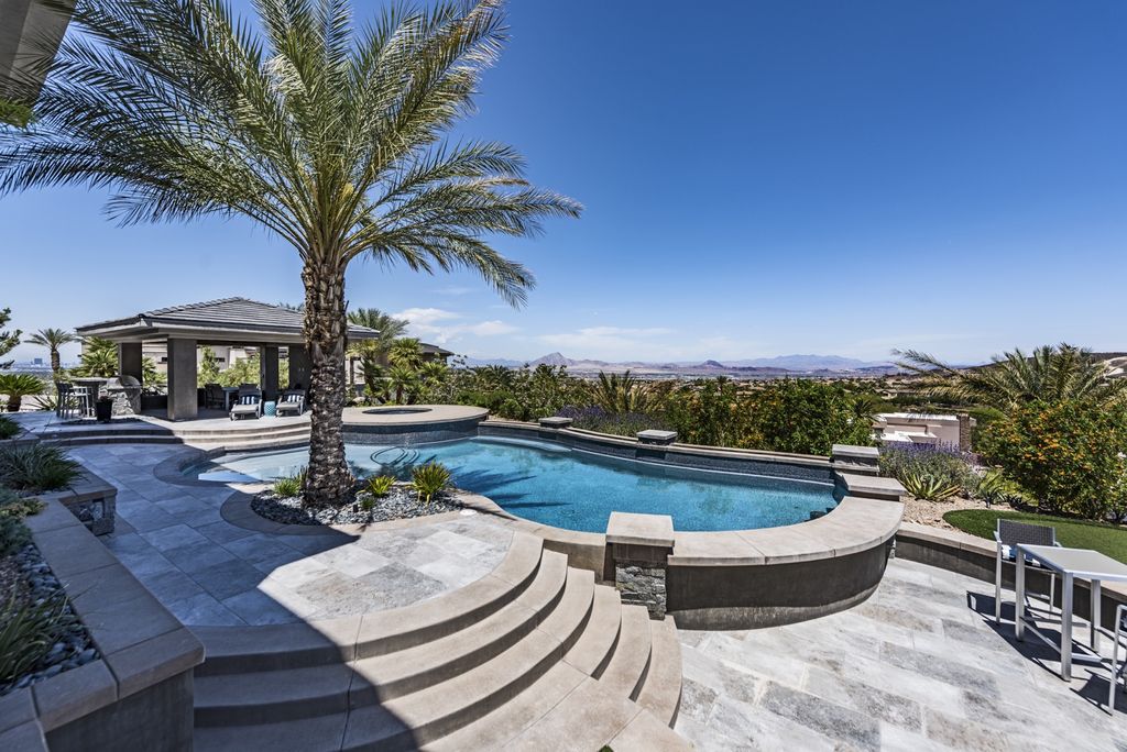 The Estate in Henderson, a custom guard-gated 2-story built on a premium hillside lot with incredible mountain, city, and golf course views is now available for sale. This home located at 1474 Reims Dr, Henderson, Nevada