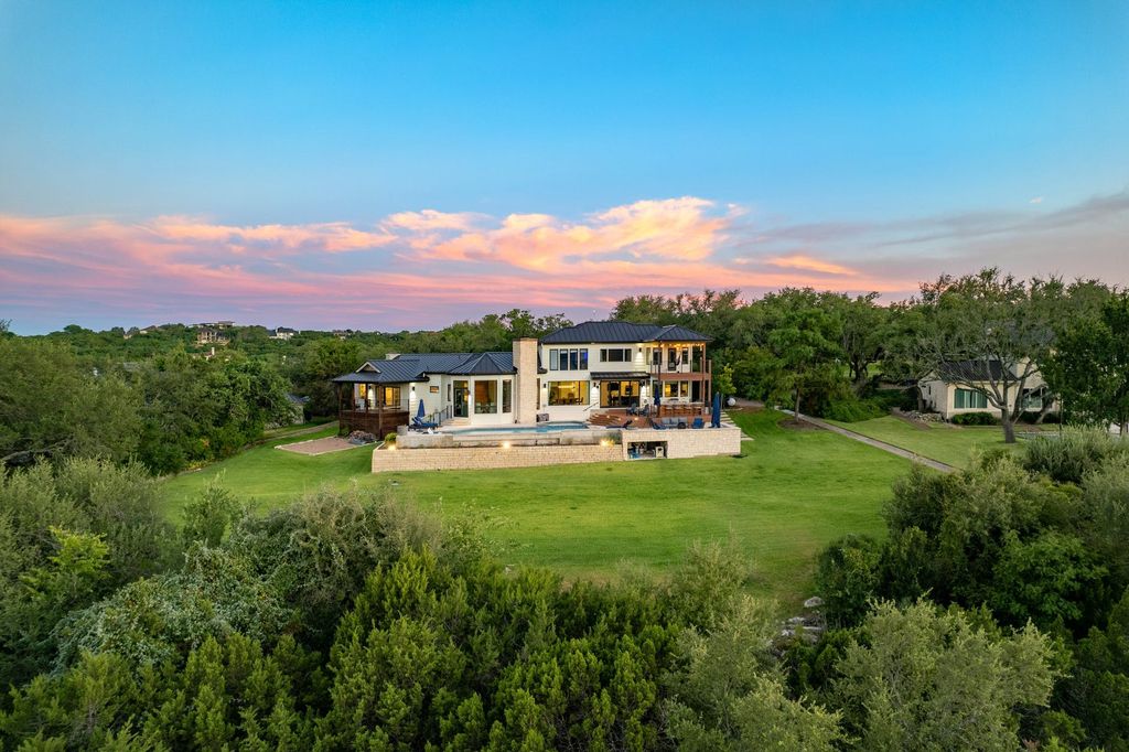 The Home in Austin, an impressive residence with thoughtful architectural detail, the finest modern fixtures, finishes throughout and sweeping hill country views. This home located at 7 Coleridge Ln, Austin, Texas.