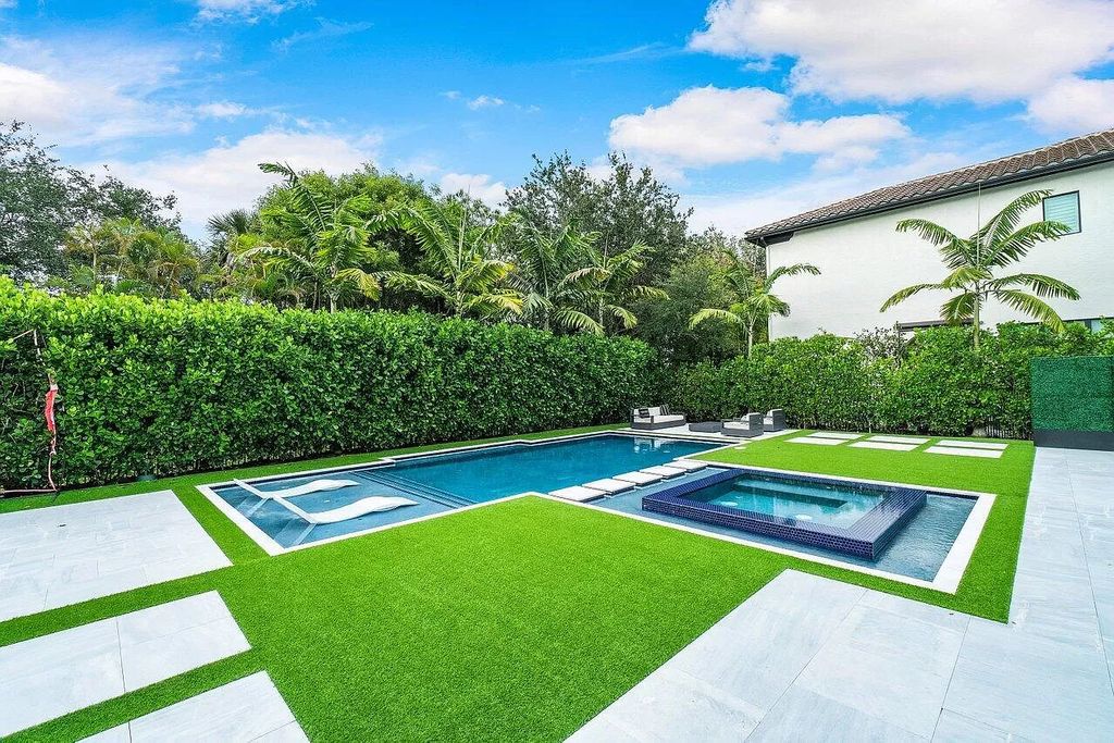 The Home in Boca Raton, a contemporary estate offers notable features include concrete construction, impact glass, custom entry ''pivot'' door, wine storage, theater room  is now available for sale. This home located at 17558 Cadena Dr, Boca Raton, Florida