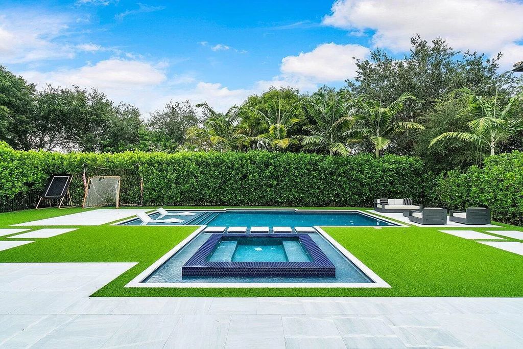 The Home in Boca Raton, a contemporary estate offers notable features include concrete construction, impact glass, custom entry ''pivot'' door, wine storage, theater room  is now available for sale. This home located at 17558 Cadena Dr, Boca Raton, Florida