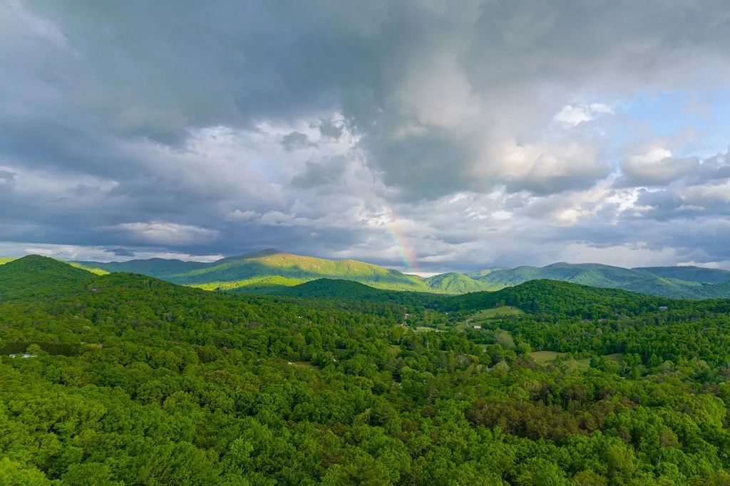 The Manor in Fairview is a modern sanctuary for those seeking the luxury, private mountain lifestyle, now available for sale. This home located at 5 Wild Wind Trl, Fairview, North Carolina