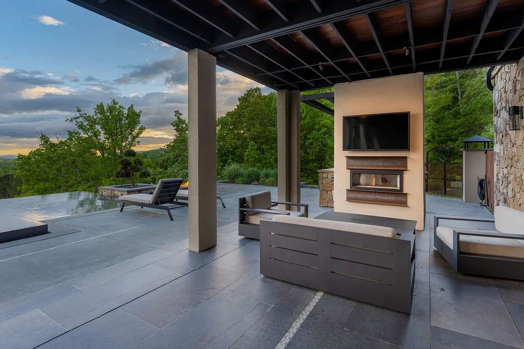 The Manor in Fairview is a modern sanctuary for those seeking the luxury, private mountain lifestyle, now available for sale. This home located at 5 Wild Wind Trl, Fairview, North Carolina