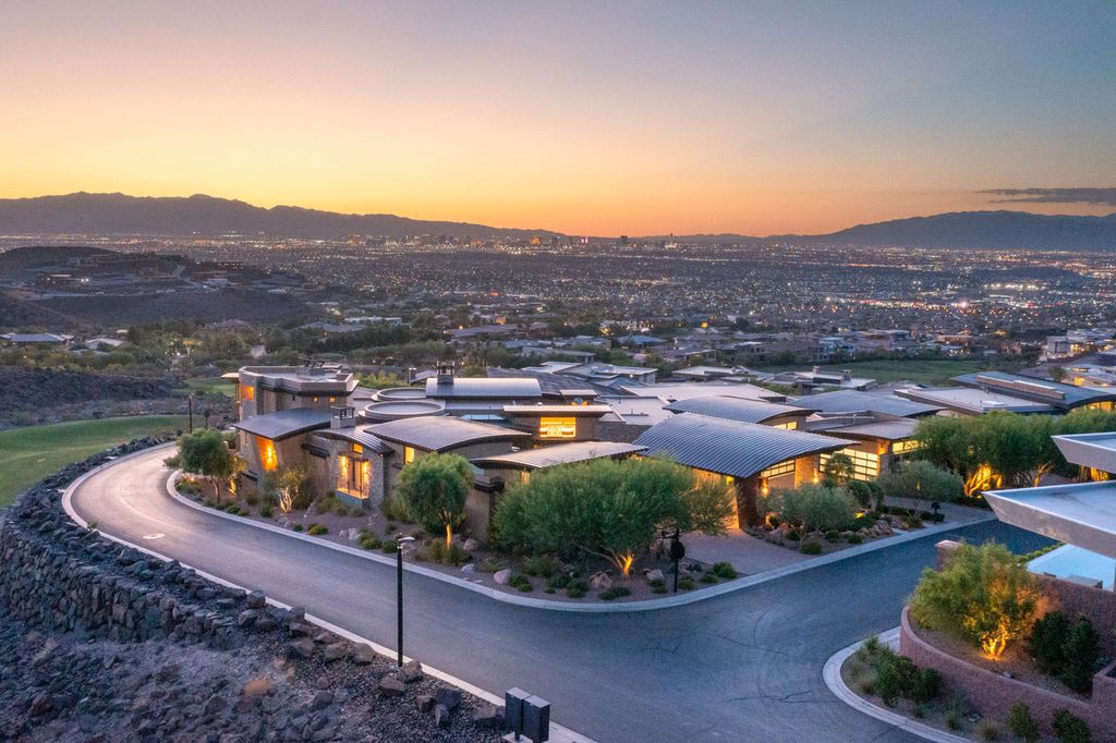 The Mansion in Henderson, an architecturally meaningful custom home perched high up in the peaks of Macdonald Highlands with spectacular views of the entire Las Vegas Valley, the Las Vegas Strip, Dragon Ridge Golf Course, and surrounding mountains. This home located at 681 Tranquil Rim Ct, Henderson, Nevada.