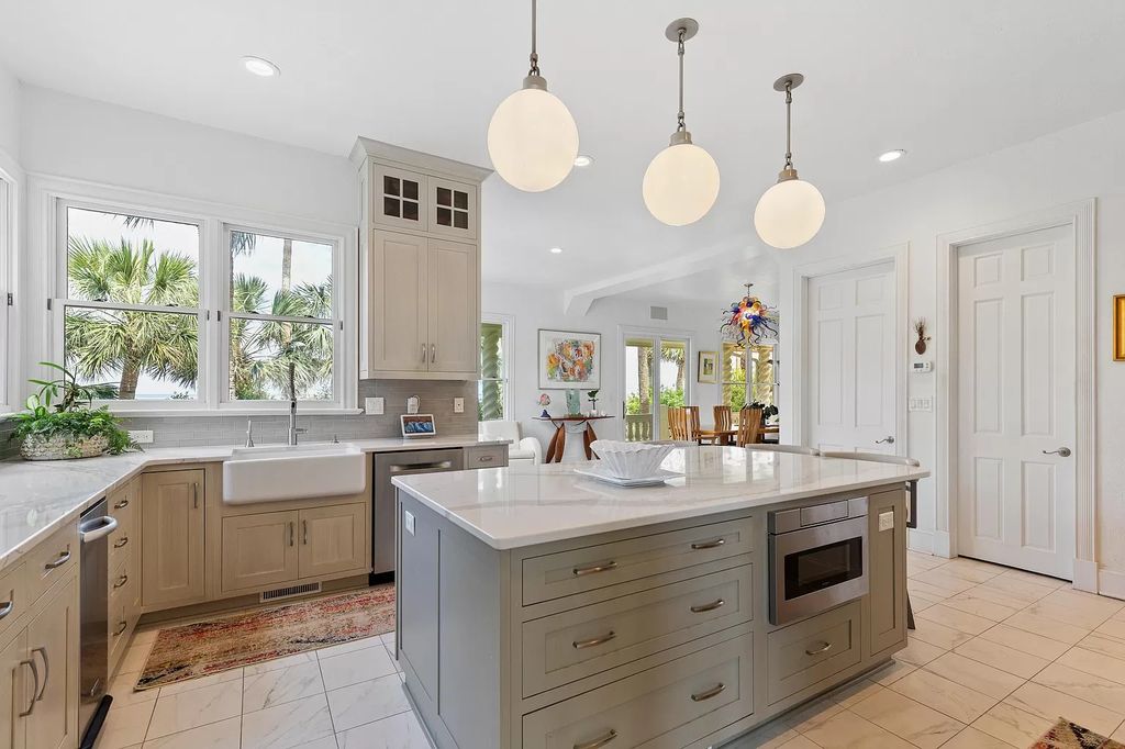 The Retreat in Isle Of Palms offers a spacious interior, inviting outdoor living spaces and mature landscaping, now available for sale. This home located at 61 Ocean Poin, Isle Of Palms, South Carolina