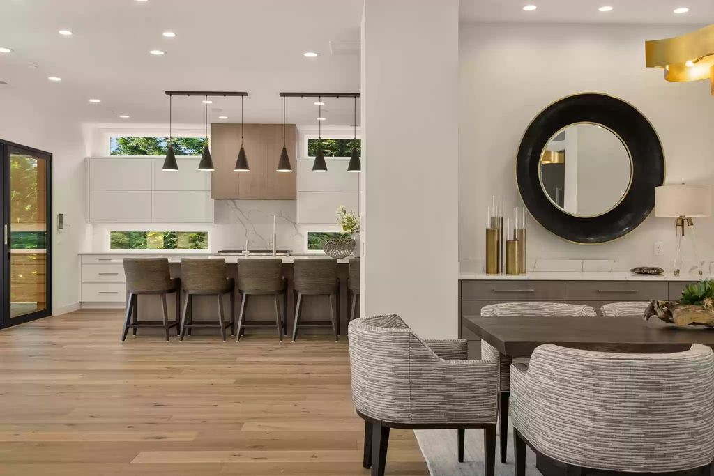 Who says every family can only have one dining area? The idea of having 2 or 3 dining areas in a home is not only possible but also incredibly effective, surpassing your imagination. In above mentioned kitchen design idea, in addition to setting up a dining room with a long table and cushioned chairs for cozy and formal gatherings, utilizing the kitchen island with minimalist wooden chairs creates one more fantastic dining area for the family. This concept offers ultimate comfort for all family members while adding a unique touch to the kitchen design. 