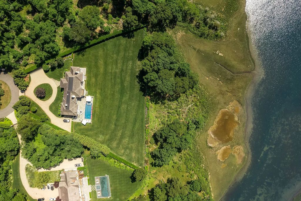 The Home in Sag Harbor, a gated residence set on a truly unique and special location with over 400 feet of direct waterfront and multiple entertaining spaces is now available for sale. This home located at 35 Ezekills Holw, Sag Harbor, New York